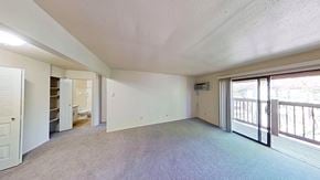 Benton Harbor apartment for rent - A spacious living room with a private balcony at Briarwood Apartments in Benton Harbor, MI