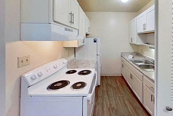 A kitchen with a sink and a refrigerator