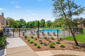 Springfield apartment for rent - A pool surrounded by a fence and a tree.