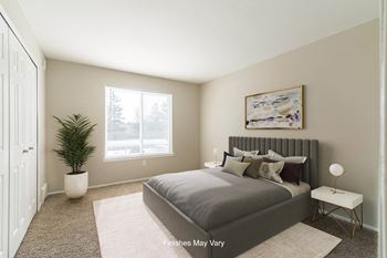 A bedroom with a large bed and a large window