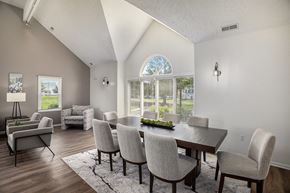 Lansing apartment for rent - A dining room with a table and chairs at Canal Club Apartments in Lansing, MI