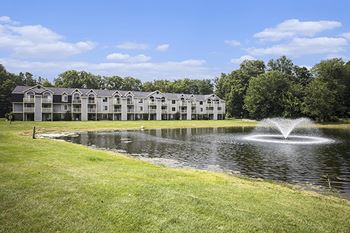 A fountain in the middle of a pond 