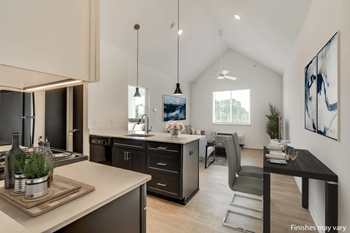 A kitchen and dining area in a 555 waverly unit