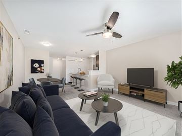 Huntsville apartment for rent - A living room with a dark blue sofa and a television.