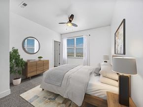 Huntsville apartment for rent - A bedroom with a bed, a ceiling fan, and a window with blinds at Chase Creek Apartment Homes, Huntsville, AL, 35811