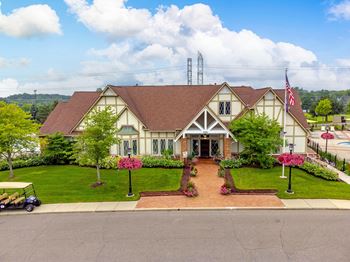 A home with a lawn and a golf cart in front of it
