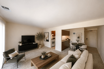 Wixom apartment for rent - A living room with a white couch and a wooden coffee table.