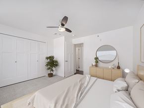 Rogers apartment for rent - A bedroom with a bed, dresser, mirror, and a ceiling fan at Dodson Pointe Apartment Homes, Rogers