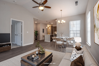 A living room and dining room with a ceiling fan