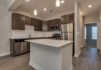 A kitchen with a large island and stainless steel appliances