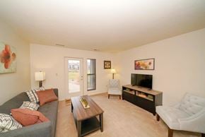 Kalamazoo apartment for rent - Living Room With French Door to Patio at Emerald Park Apartments, Michigan