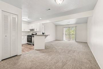 Kalamazoo apartment for rent - A kitchen with white cabinets and a white island with a window.