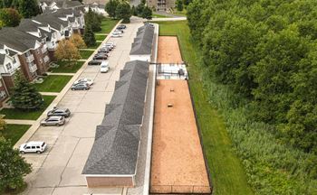 A long parking lot with cars parked in it