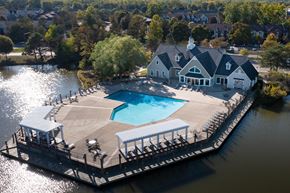 Westland apartment for rent - A large house with a pool is surrounded by water at The Landings Apartments, Westland