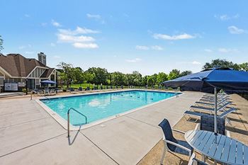 Outdoor swimming pool with lounge chairs and umbrellas