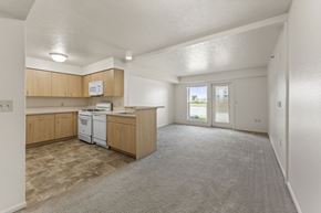 Ankeny apartment for rent - A kitchen with wooden cabinets and a white dishwasher at Fieldstream Apartment Homes, Iowa