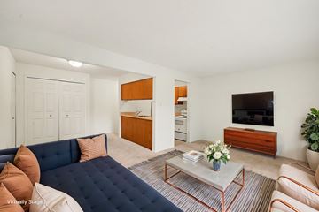 Batavia apartment for rent - A living room with a blue couch and a television.