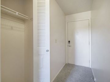 Portage townhouse for rent - A white door with a keypad entry system is in a hallway.