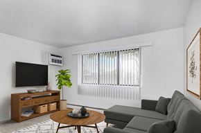 Muskegon apartment for rent - A garden style living room with a large window at Glen Oaks Apartments, Michigan, 49442