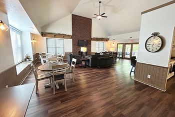 A community building with a hard-surface floor and a brick fireplace wall