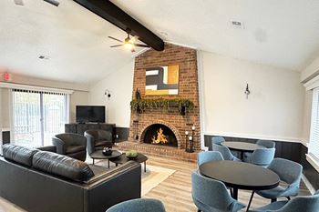 A community room with a fireplace and a television
