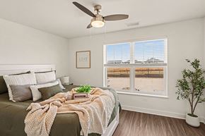 Lincoln apartment for rent - A bedroom with a bed, large windows and a ceiling fan at The Grove Apartment Homes, Nebraska
