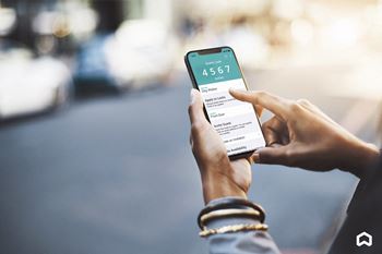 A person holding a smartphone with the uber app on the screen