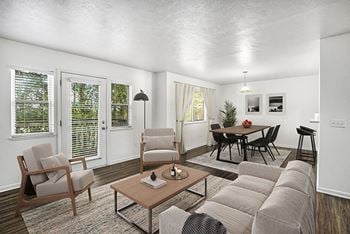 A dining room with a vinyl-plank floors and a table with chairs