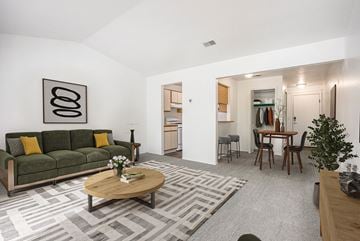 Walker apartment for rent - A living room with a green couch and a coffee table.