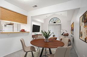 Walker apartment for rent - A dining room leading to a living room with a cathedral ceiling at Hampton Lakes Apartments, Michigan, 49534