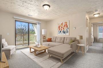 Mishawaka apartment for rent - A living room with a couch, a coffee table, and a painting on the wall.