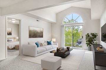 Elkhart apartment for rent - A living room with a large window and a painting on the wall.