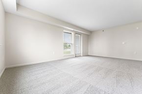 Champaign apartment for rent - End style living room with a large window and a door  at Hunters Pond Apartment Homes, Champaign, IL, 61820