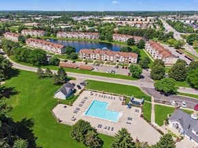 Mishawaka apartment for rent - A large apartment complex with a swimming pool in the foreground at Indian Lakes Apartments, Mishawaka, Indiana