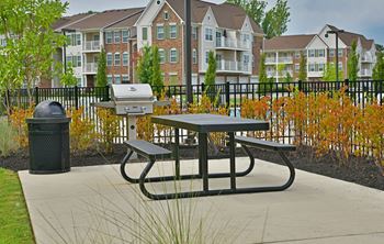 A picnic table in front of an apartment complex