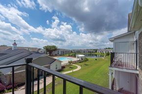 Columbia townhouse for rent - A view from a balcony overlooking a pool and a lake.