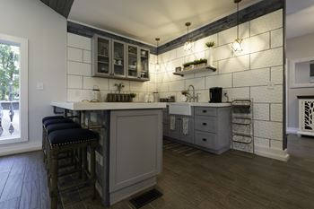 A kitchen with a bar area and a window