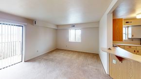 Fort Wayne apartment for rent - An enlarged living room with a window and sliding glass doors at Liberty Mills Apartments, Fort Wayne