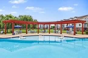 Madison apartment for rent - A pergola is over a pool with large sundeck at Limestone Creek Apartment Homes, 35756