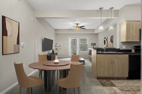 Elkhorn townhouse for rent - A modern dining room with a round table and chairs at Lynbrook Apartments and Townhomes, Elkhorn, NE, 68022