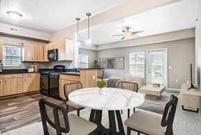 Elkhorn townhouse for rent - A kitchen with a window, and living room with a ceiling fan at Lynbrook Apartments and Townhomes, Elkhorn, NE, 68022