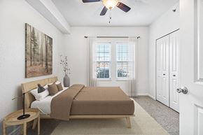 Elkhorn townhouse for rent - A bedroom with large windows and a ceiling fan at Lynbrook Apartments and Townhomes, Elkhorn, NE, 68022
