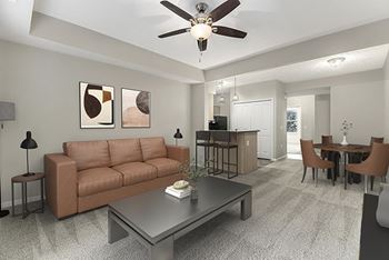 A living room with a couch, a coffee table, and a ceiling fan