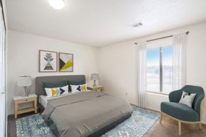 Kalamazoo apartment for rent - A bedroom with a bed, chair, and a window at Madeira Apartments in Kalamazoo, MI 49001