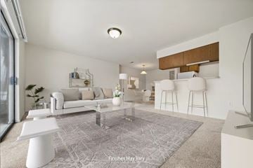 Peoria apartment for rent - A modern living room with a white sofa and a grey rug.