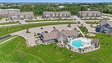 Grand Rapids apartment for rent - A large house with a pool in the middle of a grassy area.