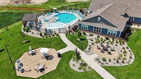 Grand Rapids apartment for rent - A pool and a patio area with grills, a fire pit, and seating areas at Meadowbrooke Apartment Homes in Grand Rapids, MI 49512