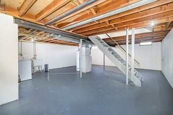 Private basement with a washer and dryer and storage space