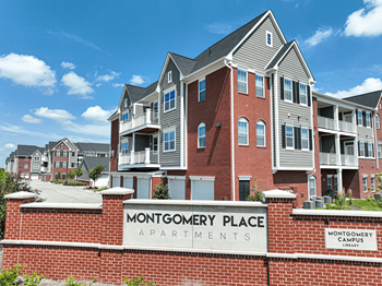 A large brick building with a sign that reads montgomery place apartments