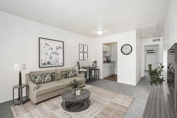 Portage apartment for rent - A living room with a couch, coffee table, and a painting on the wall.